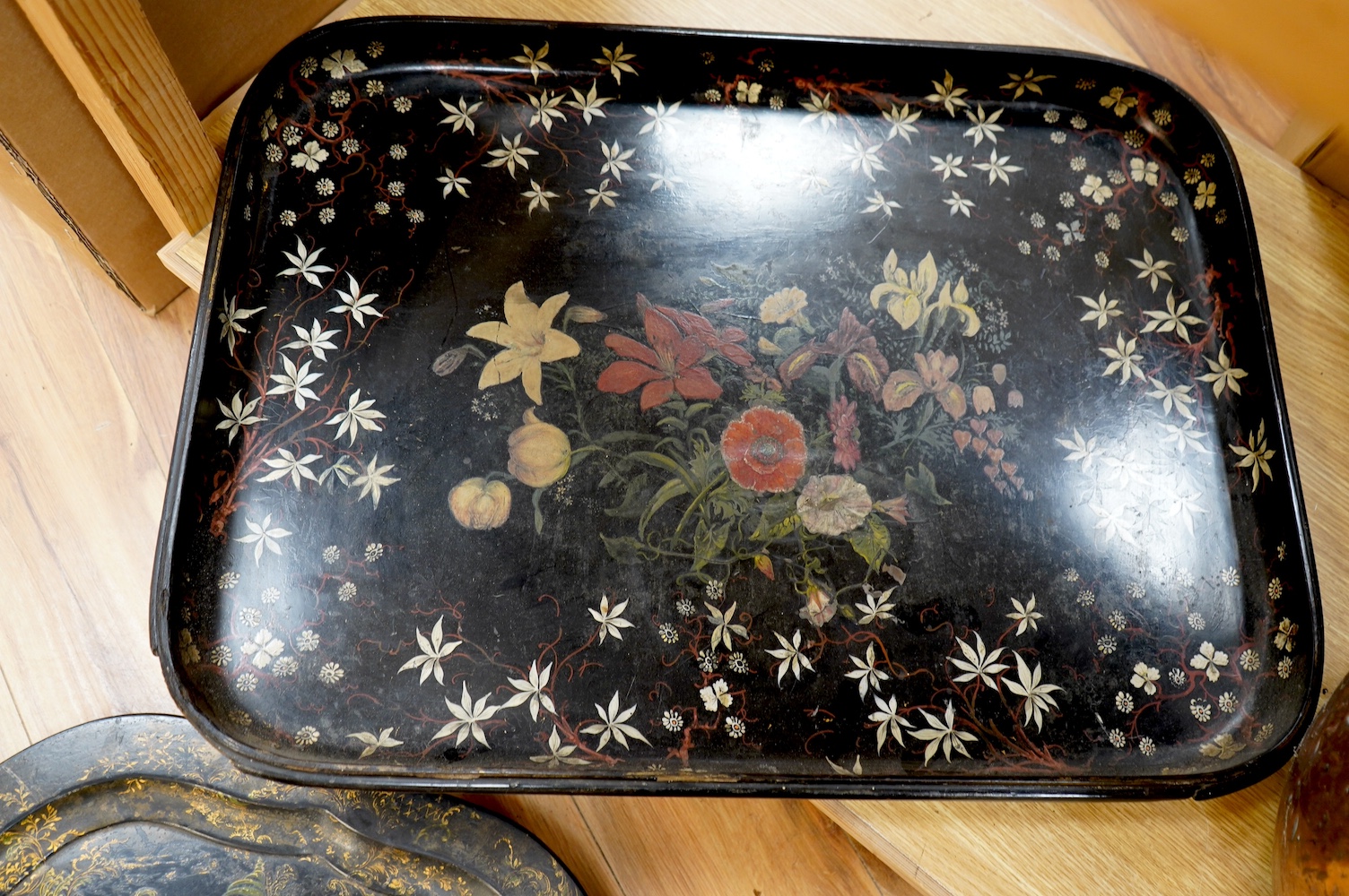 Three large Victorian papier mâché trays, largest 71cm wide. Condition - all have faults